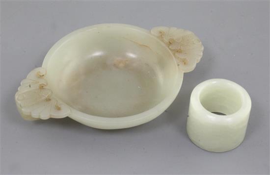 A Chinese pale celadon jade small brush washer and an archers ring, 2.7cm and 10.2cm